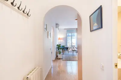 a hallway with an archway in a home at Cozy Apt with charm and exquisite natural light in Barcelona