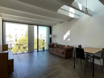 a living room with a couch and a table at loft en el centro in Vilanova i la Geltrú