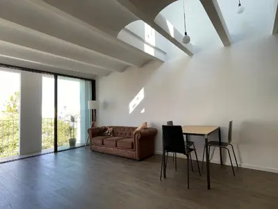 a living room with a couch and a table at loft en el centro in Vilanova i la Geltrú