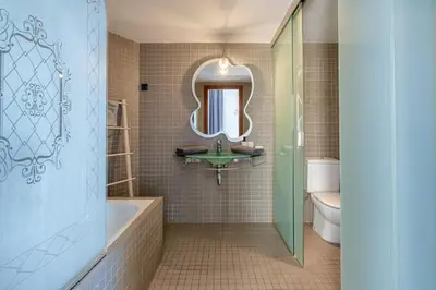 a bathroom with a tub and a sink and a mirror at Espectacular loft en centrico edificio singular in Manresa