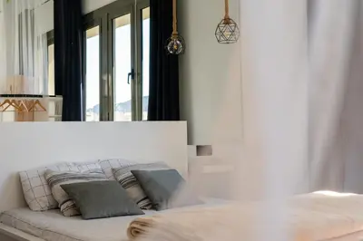 a white couch with pillows in a room with windows at Espectacular loft en centrico edificio singular in Manresa