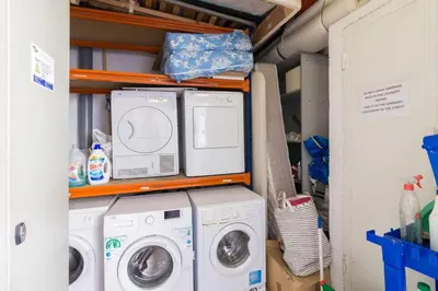 a laundry room with two washers and a dryer at Barnapartments Raval in Barcelona