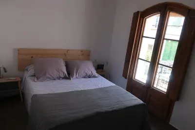 a bed with two pillows and a window in a room at CAM Maresme 2 Apartamento Barcelona y playa in Masnou
