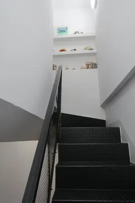 a staircase in a building with black escalators at CAM Maresme 2 Apartamento Barcelona y playa in Masnou