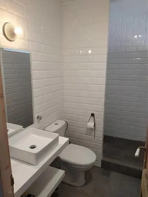 a white bathroom with a toilet and a sink at CAM Maresme 2 Apartamento Barcelona y playa in Masnou