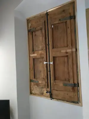 a wooden door on a wall in a room at CAM Maresme 2 Apartamento Barcelona y playa in Masnou