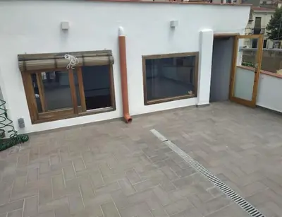 a building with two doors and a patio at CAM Maresme 1 apartamento Barcelona y playa in Masnou