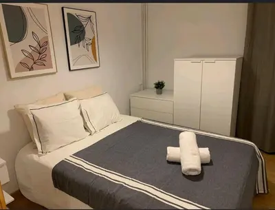 a bedroom with a bed with two towels on it at Barcelona estadio nuevo in Hospitalet de Llobregat