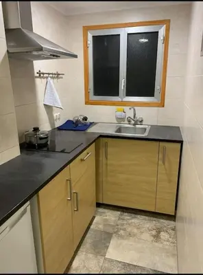 a small kitchen with a sink and a window at Barcelona estadio nuevo in Hospitalet de Llobregat