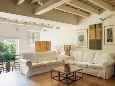 a living room with two white couches and a table at Les Canes 2 in Aiguafreda