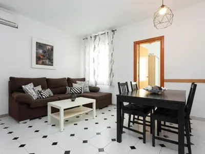a living room with a couch and a table at Click&Flat Fira Castelao in Hospitalet de Llobregat