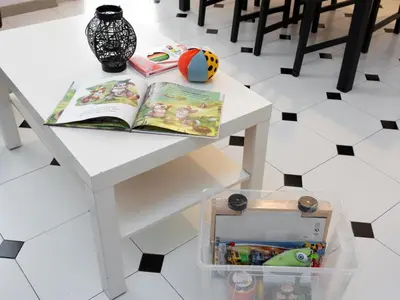 a white table with a book and a toy box on it at Click&Flat Fira Castelao in Hospitalet de Llobregat