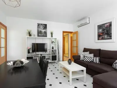a living room with a couch and a table at Click&Flat Fira Castelao in Hospitalet de Llobregat
