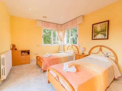 two beds in a room with yellow walls at Holiday Home Aurea by Interhome in Pineda de Mar