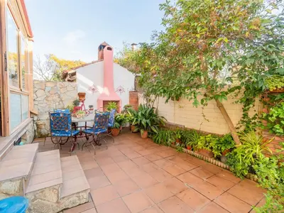 a patio with a table and chairs and a building at Holiday Home Aurea by Interhome in Pineda de Mar