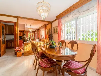 a kitchen and dining room with a wooden table and chairs at Holiday Home Aurea by Interhome in Pineda de Mar