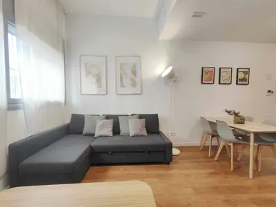 a living room with a couch and a table at Mazi Apartments Loft in Mataró