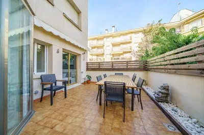 a patio with a table and chairs on a balcony at HomeHolidaysRentals Liberty - Costa Barcelona in Pineda de Mar