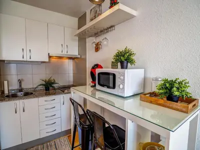 a kitchen with a counter top with a microwave at The Blue Island Loft by Hello Homes Sitges in Sitges