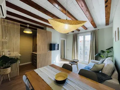 a dining room with a table and a couch at The Collection Barcelona - Plaza Catalunya Recently renovated 5BD-4BTH in Barcelona