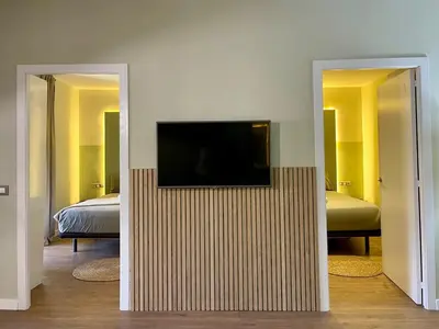 a living room with a couch and a table at The Collection Barcelona - Plaza Catalunya Recently renovated 5BD-4BTH in Barcelona