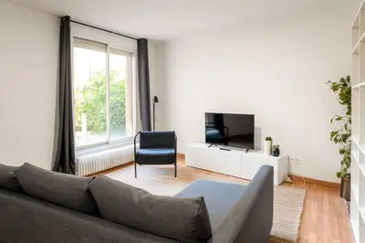 a living room with a couch and a tv at The Collection Barcelona - Plaza Urquinaona Central and comfortable 3BD in Barcelona