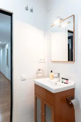 a bathroom with a sink and a mirror at The Collection Barcelona - Plaza Urquinaona Central and comfortable 3BD in Barcelona