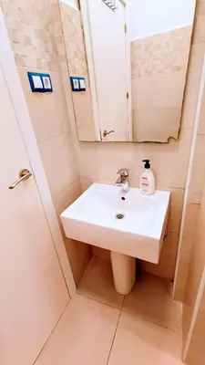 a bathroom with a white sink and a mirror at Hostal Estudios in Badalona