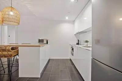 a kitchen with white walls and a counter top at CATERINA 22@ POBLENOU in Barcelona