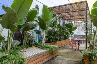 a patio with a chair and a bunch of plants at CATERINA 22@ POBLENOU in Barcelona