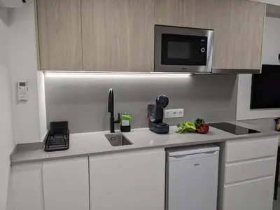 a kitchen with a white counter top with a microwave at WEFLATING Fira in Hospitalet de Llobregat