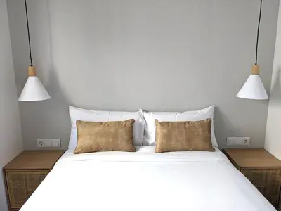 a bedroom with a large white bed with two pillows at WEFLATING Fira in Hospitalet de Llobregat