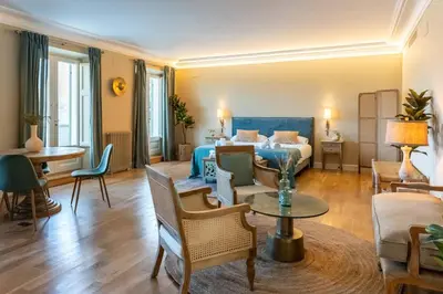 a hotel room with a bed and a living room at Hotel Font de la Canya in Avinyonet
