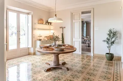 a living room with a table and a kitchen at Hotel Font de la Canya in Avinyonet