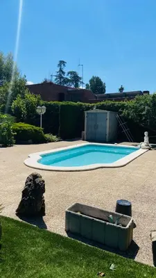 a small blue swimming pool in a yard at Villa Òdena in Odena