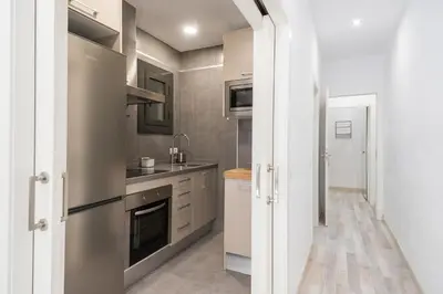 a kitchen with a sink and a stove at Apartment Next to Sagrada Familia, the Essence of Barcelona in Barcelona