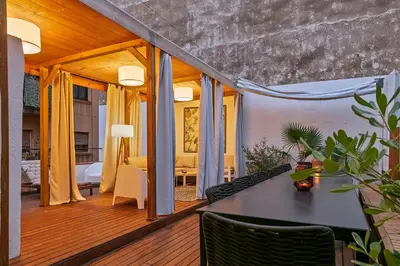 a living room with a table and a bedroom at Penthouse with Rooftop apartment in the Barceloneta - Barcelona in Barcelona