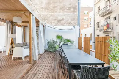 a balcony with a black table and chairs at Penthouse with Rooftop apartment in the Barceloneta - Barcelona in Barcelona