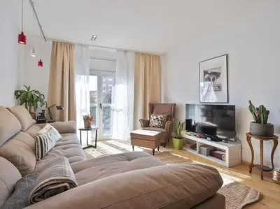 a living room with a couch and a television at BCN: ¡Exclusivos y cerca del Camp Nou! in El Arrabal