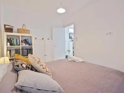 a bedroom with a large bed with pillows on it at BCN: ¡Exclusivos y cerca del Camp Nou! in El Arrabal