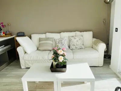 a living room with a white couch and a table at La Marina2 SeaView with amazing terrace in Sitges