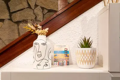 a white vase sitting on top of a shelf at Barcelona Beach Home in Barcelona