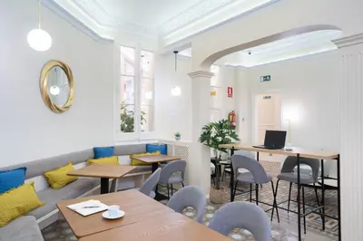 a restaurant with tables and chairs in a room at Feelathome Casa Bertrand in Barcelona