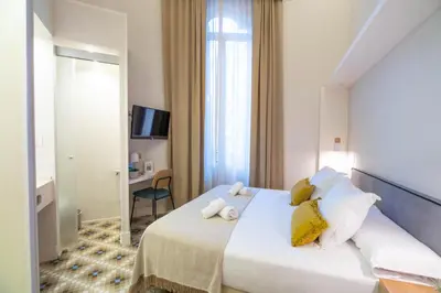 a bedroom with a large white bed with yellow pillows at Feelathome Casa Bertrand in Barcelona