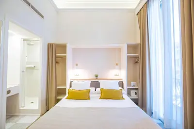 a bedroom with a large bed with yellow pillows at Feelathome Casa Bertrand in Barcelona