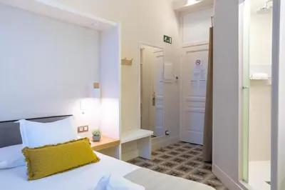 a hotel room with a bed and a hallway at Feelathome Casa Bertrand in Barcelona