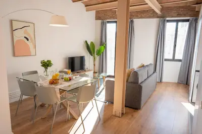 a living room with a table and a couch at Feelathome Stadium Apartments in Hospitalet de Llobregat