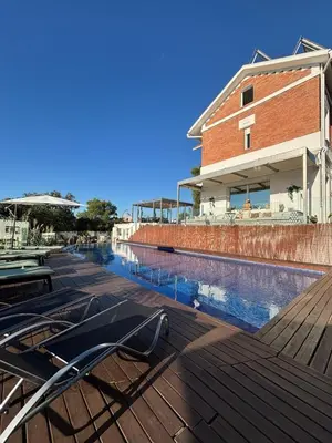 a swimming pool with chairs on a deck next to a building at Spirit of Queen experience in Barcelona