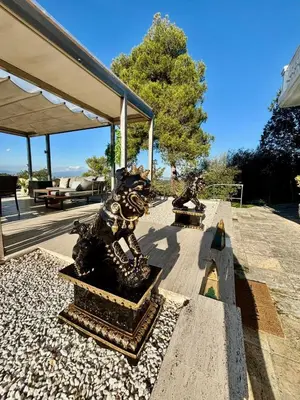 a couple of statues sitting on top of a patio at Spirit of Queen experience in Barcelona