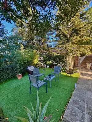 a yard with chairs and a table on the grass at Spirit of Queen experience in Barcelona